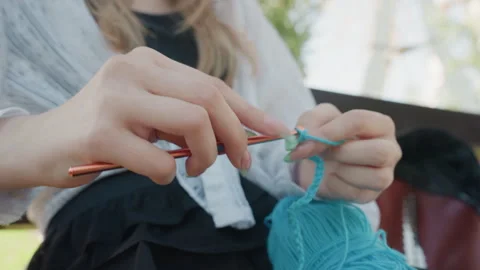 Close up of hands crocheting with turquoise yarn and copper hook detailed finger Video stock 345841764