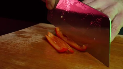 Close up hands cutting bell pepper in slow motion in a dark kitchen Video stock 153206568