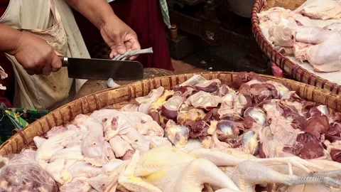 Close-up of hands cutting chicken meat in a traditional market Stock Footage 292906615