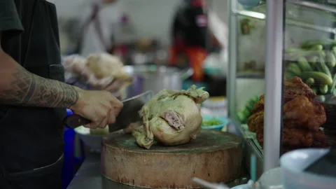 Close up of hands cutting chicken to prepare street food in bangkok Stock Footage 232328076