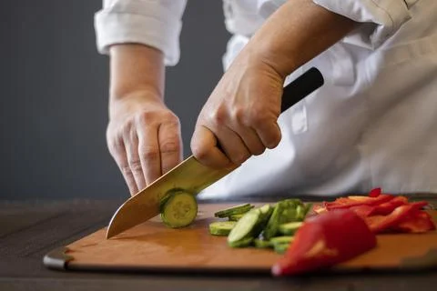 Close up hands cutting cucumber. High quality photo Stock Photos