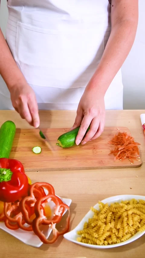 Close up hands cutting cucumber , preparing for a healthy organic vegetarian Stock Footage 204677257