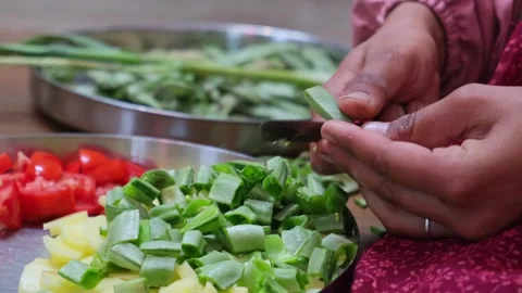 Close-up of hands cutting fresh green flat beans and tomatoes Stock Footage 329370735