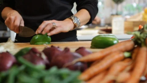 Close up of hands cutting a green pepper. Preparing food in the kitchen. Stock Footage 106078382