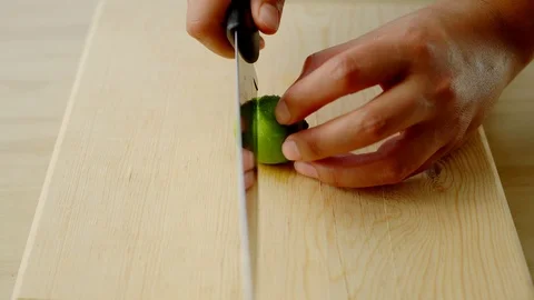 CLOSE UP OF HANDS CUTTING A LEMON Stock Footage 107287424