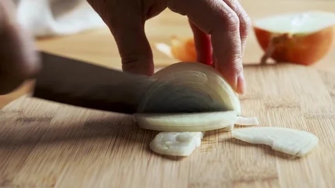 Close-up of hands cutting onions with a knife Stock Footage 257765657