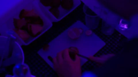 Close-up of hands cutting orange in blue light in the bar Stock Footage 223346167