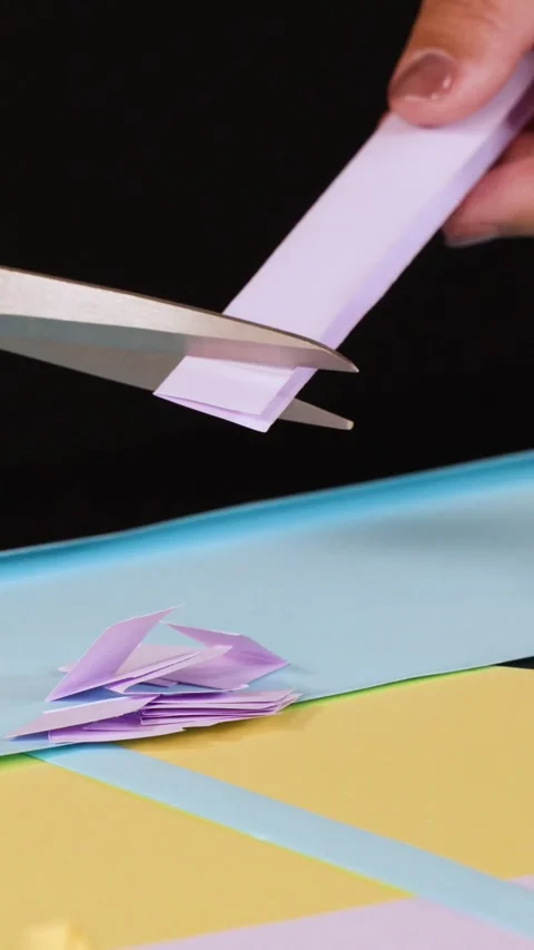 Close Up of Hands Cutting Purple Paper with Scissors for Crafting Stock Footage 327710658