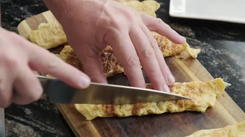 Close up hands cutting Ready-made omelet for sushi Stock Footage 290449710