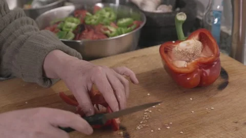 Close up of hands cutting a red bell pepper for cooking 스톡 동영상 331218562
