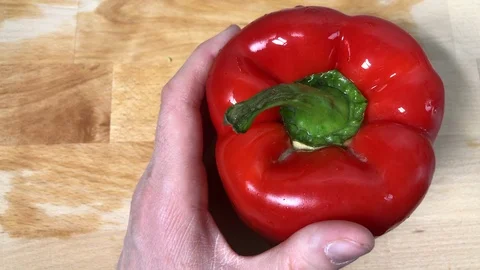 Close up of hands cutting a red pepper uncooked on a wooden cutting board. Stock-Footage 86131362