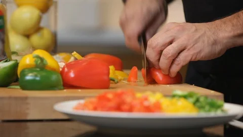 Close up of hands cutting a red pepper.  Stock Footage 106077658