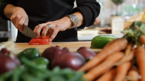 Close up of hands cutting a red pepper. Preparing food in the kitchen. Stock Footage 106078359