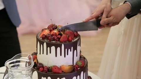 Close up hands cutting wedding cake on wedding party Stock Footage 94388903