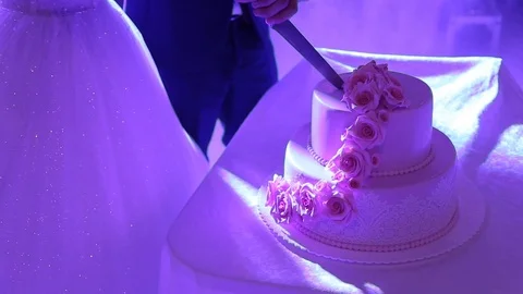 Close-up hands cutting wedding cake at the party. Stock Footage 120154842
