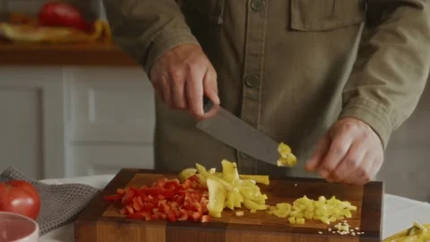 Close-up of hands cutting yellow pepper on board Stock Footage 316580913