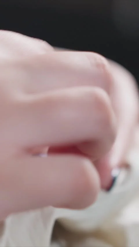 Close up of hands with dark nail polish sewinging white fabric featuring sewing Stock Footage 346796214
