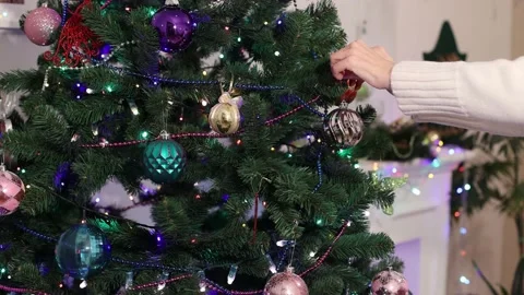 Close-up of hands decorating Christmas tree with balls. Stock Footage 166435263