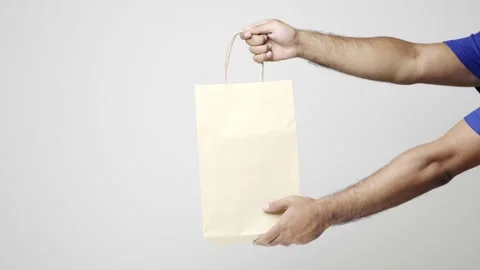 Close up hands delivery man sending the paper bag to customer on isolated white  Stock Footage 144258008