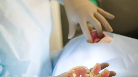 A close-up of the hands of the dental surgeon Stock Footage 236046696