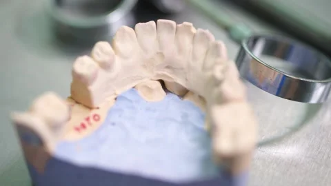 Close up hands dentist makes a denture tooth cleanliness doctor Video stock 137402427