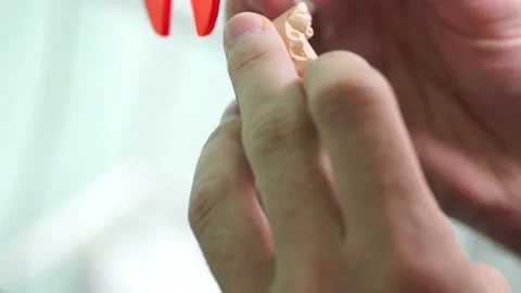 Close up hands dentist makes a denture tooth cleanliness doctor Video stock 137402465