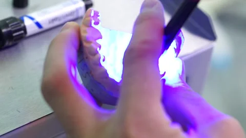 Close up hands dentist makes a denture tooth cleanliness doctor Video stock 137404994