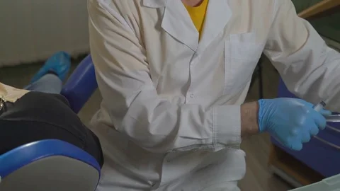 Close-Up,hands of a Dentist Put The Needle on The Syringe With an Antiseptic Stock Footage 76557853