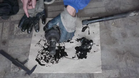 Close up of Hands Disassembling Car Axle and Triple Roller Bearing Stockbeeldmateriaal 347069606