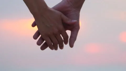 Close-up of hands disconnected from sunlight flare in background. A beautiful Stock Footage 138608256