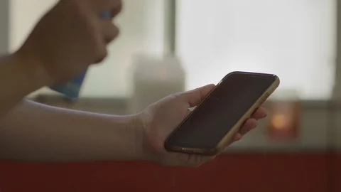 Close-up of hands disinfecting cellphone during quarantine Stock Footage 127196092