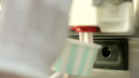 Close up of hands dispensing ice cream from machine. Stock Footage 63636170
