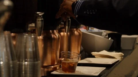 Close-up of hands dispensing iced tea into cup Stock-Footage 118975610