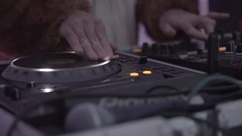 Close up of hands of a dj dressed in a fluffy costume playing and Stock Footage 239710797
