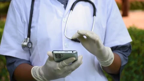 Close up of hands of doctor using smartphone for registration of vaccination. Du Stock Footage 161037000