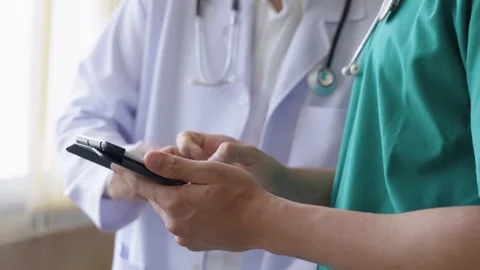 Close up hands of doctors using digital tablet to check patient treatment Stock Footage 312806088