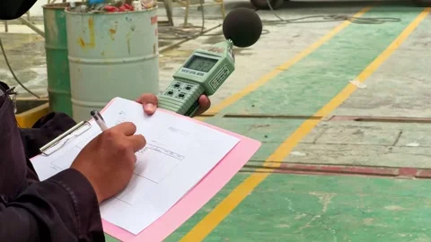 Close-up of hands documenting noise measurements with a professional sound Stock Footage 324374050
