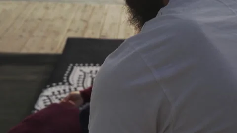 Close up hands doing thai yoga massage for a woman at sunset seashore Stock Footage 130780861