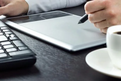Close-up of hands drawing on graphic tablet Stock Photos