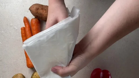 Close-up of hands drying fresh vegetables with a paper towel after washing,.. Stock Footage 320955679