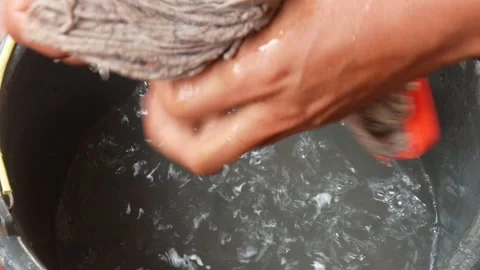 Close up of hands drying a mop from water Stock Footage 307017237