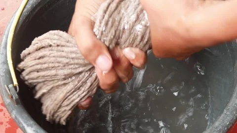 Close up of hands drying a mop from water Stock Footage 307017242