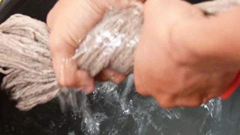 Close up of hands drying a mop from water Stock Footage 307017243