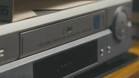 Close-up of hands ejecting VHS cassette tape from video player Stock Footage 313462805
