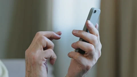 Close-up hands elderly man holding telephone typing text message making online Stock Footage 168622180