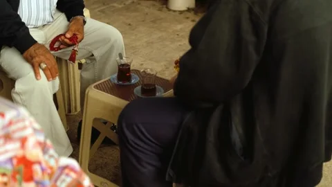 Close-up of hands of elderly Turkish men drinking tea Video stock 268684313