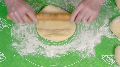 Close-up, Hands of an Elderly Woman with the help of a Wooden Roller Rolling A Stock Footage 87938306