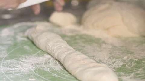 Close-up, the Hands of an Elderly Woman Slice the Dough with a Knife from Stock Footage 92756873