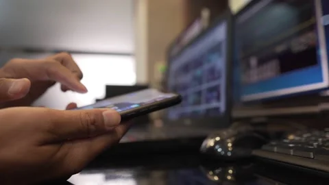 Close-up the hands of engineers with smartphones, operating in the control room Stock Footage 133486861