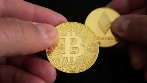 Close-up of hands exchanging two types of virtual currencies Stock Footage 169643066